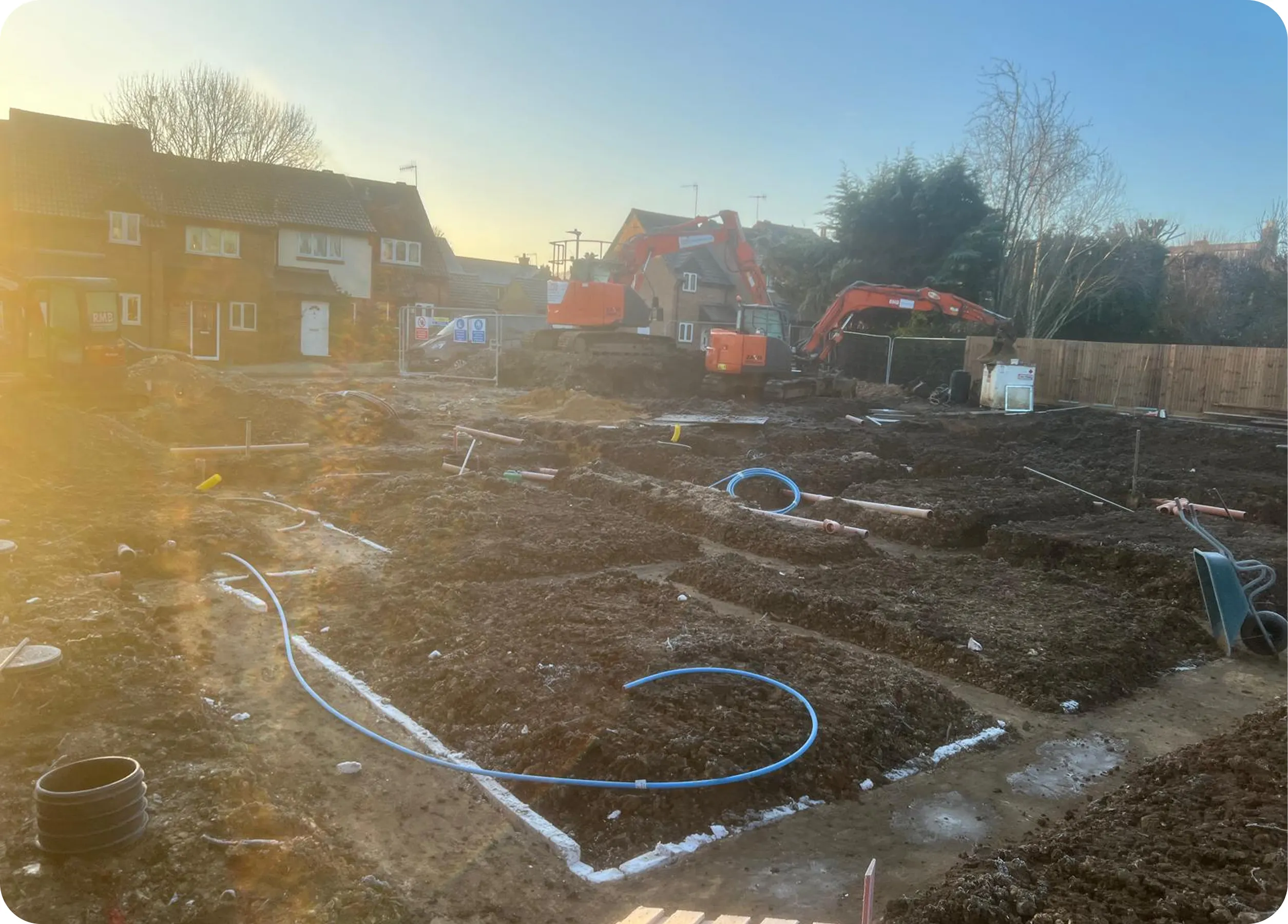 Drainage pipes laid out across a new-build excavation
