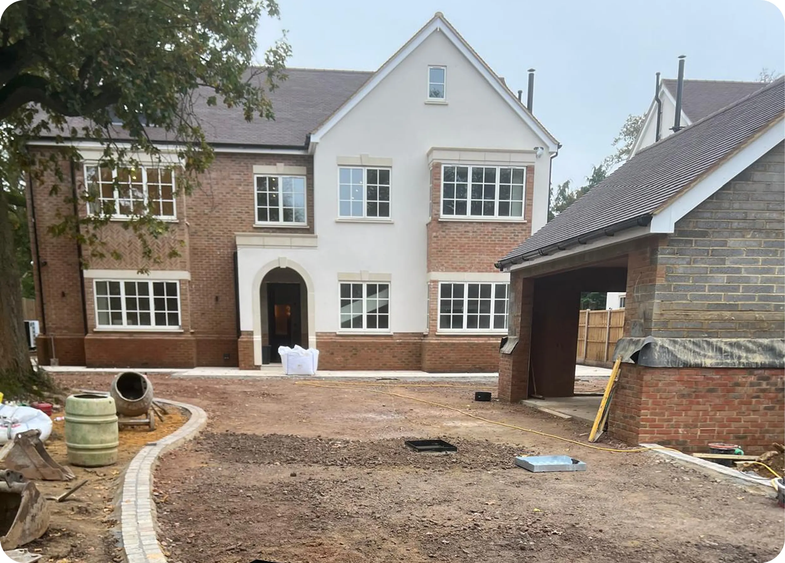 New house with a prepared driveway and drainage