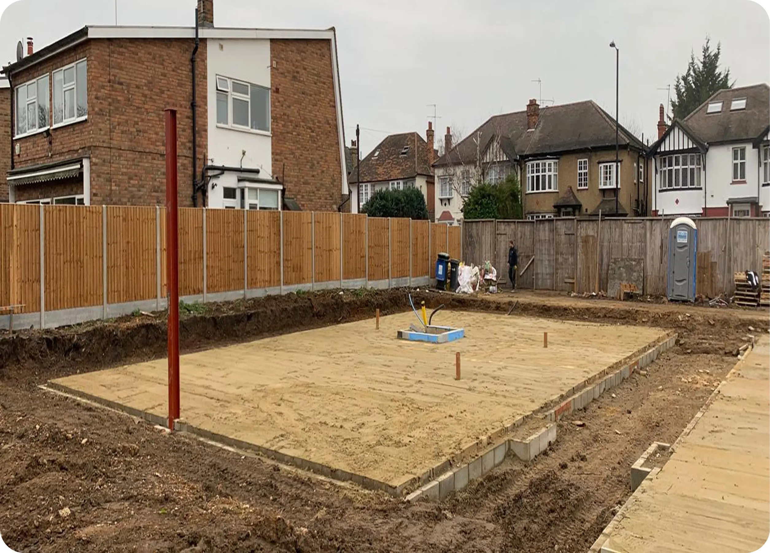 Prepared block and beam floor slab beside neighbouring houses