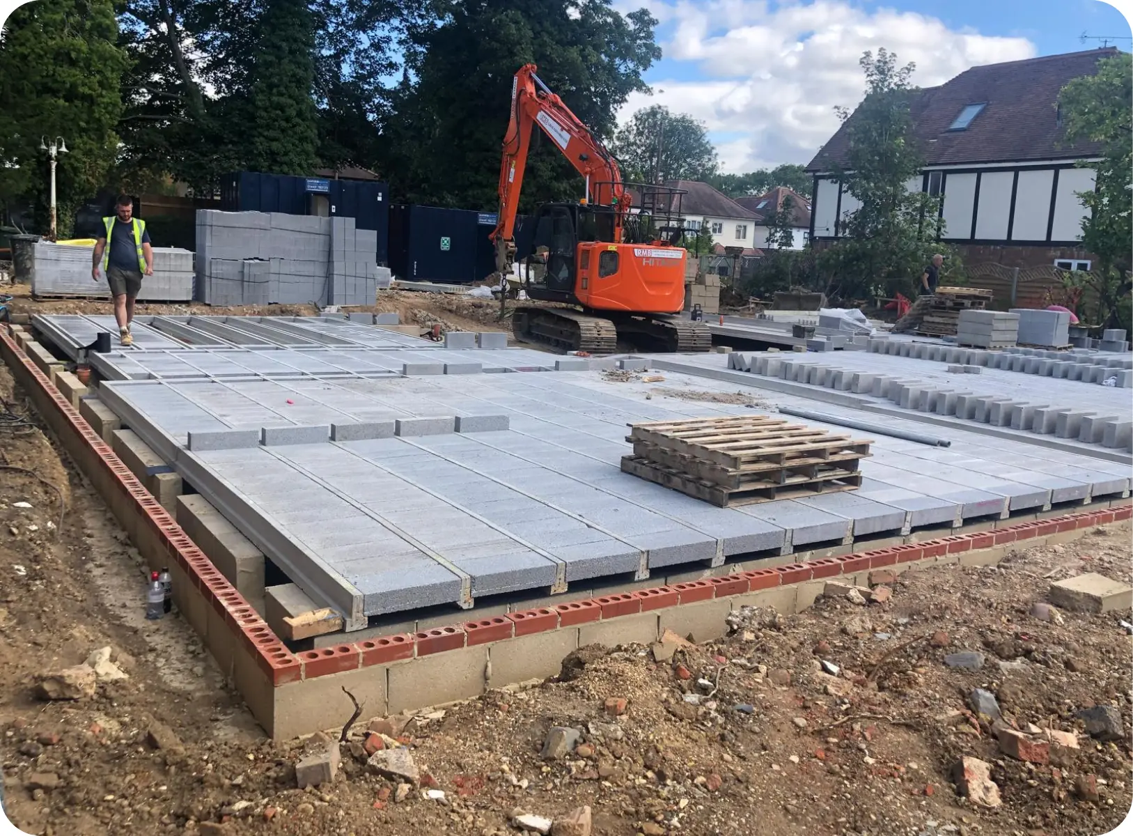 Block and beam floor being laid beside an excavator