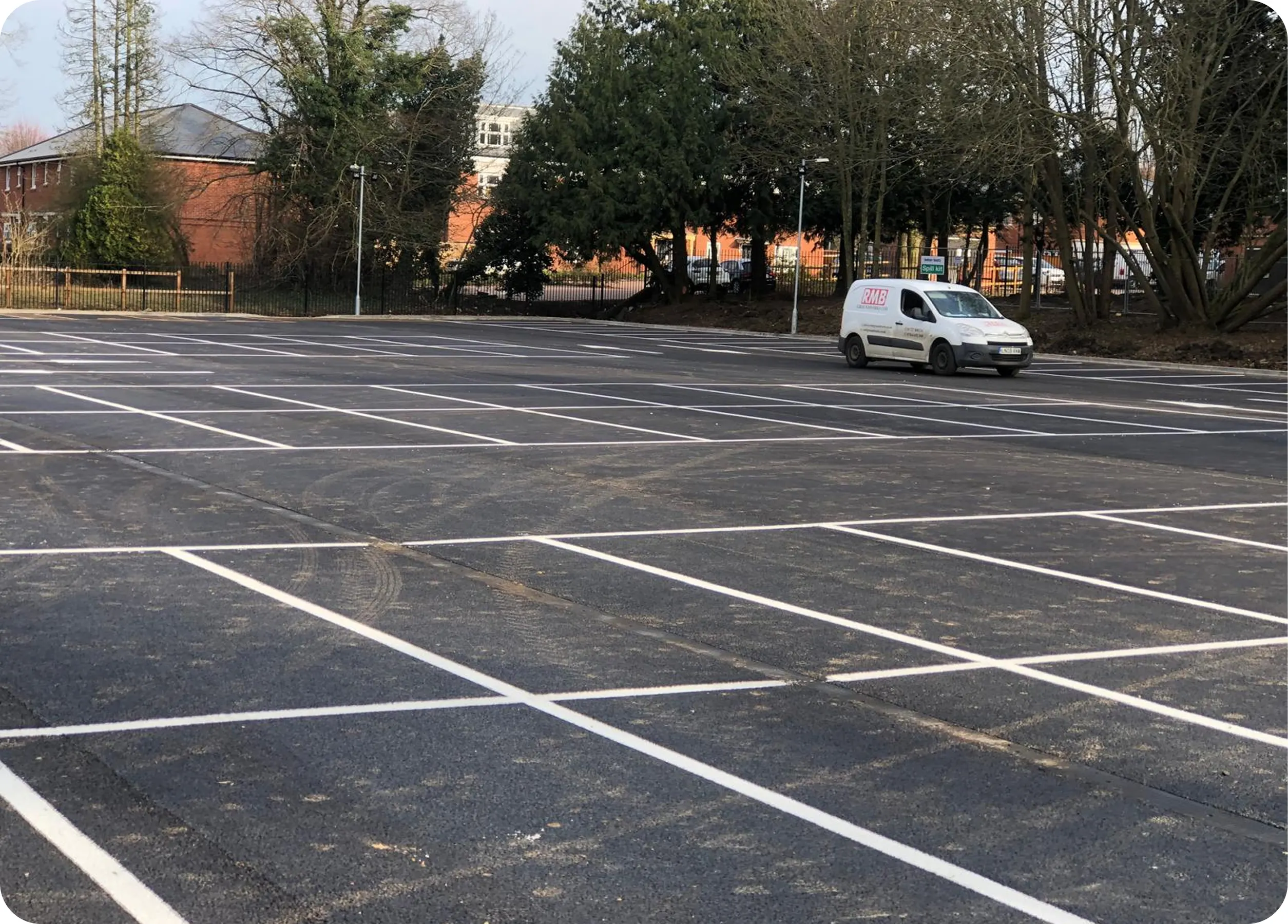 Completed car park with marked bays and an RMB van