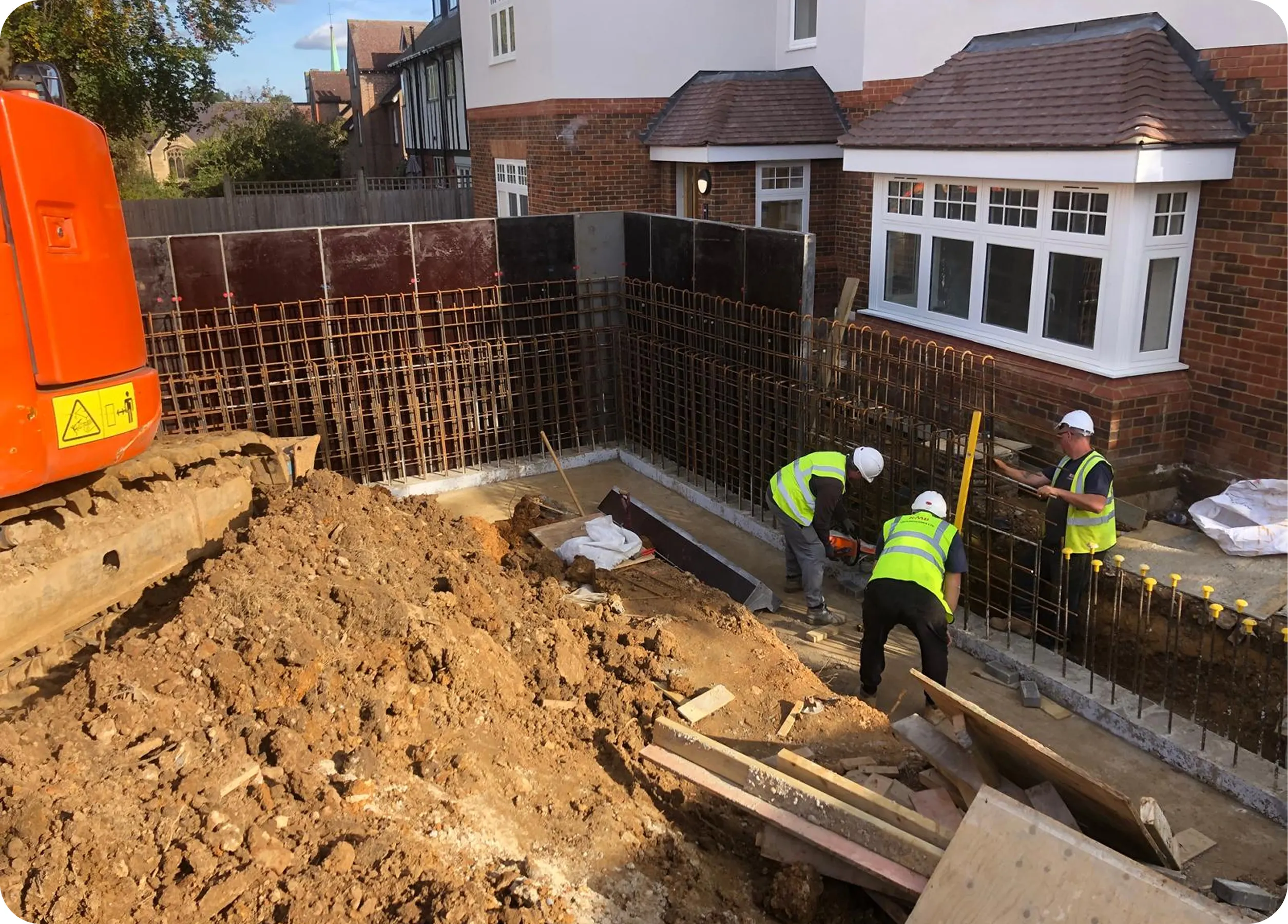 Basement reinforcement being fixed beside an excavator