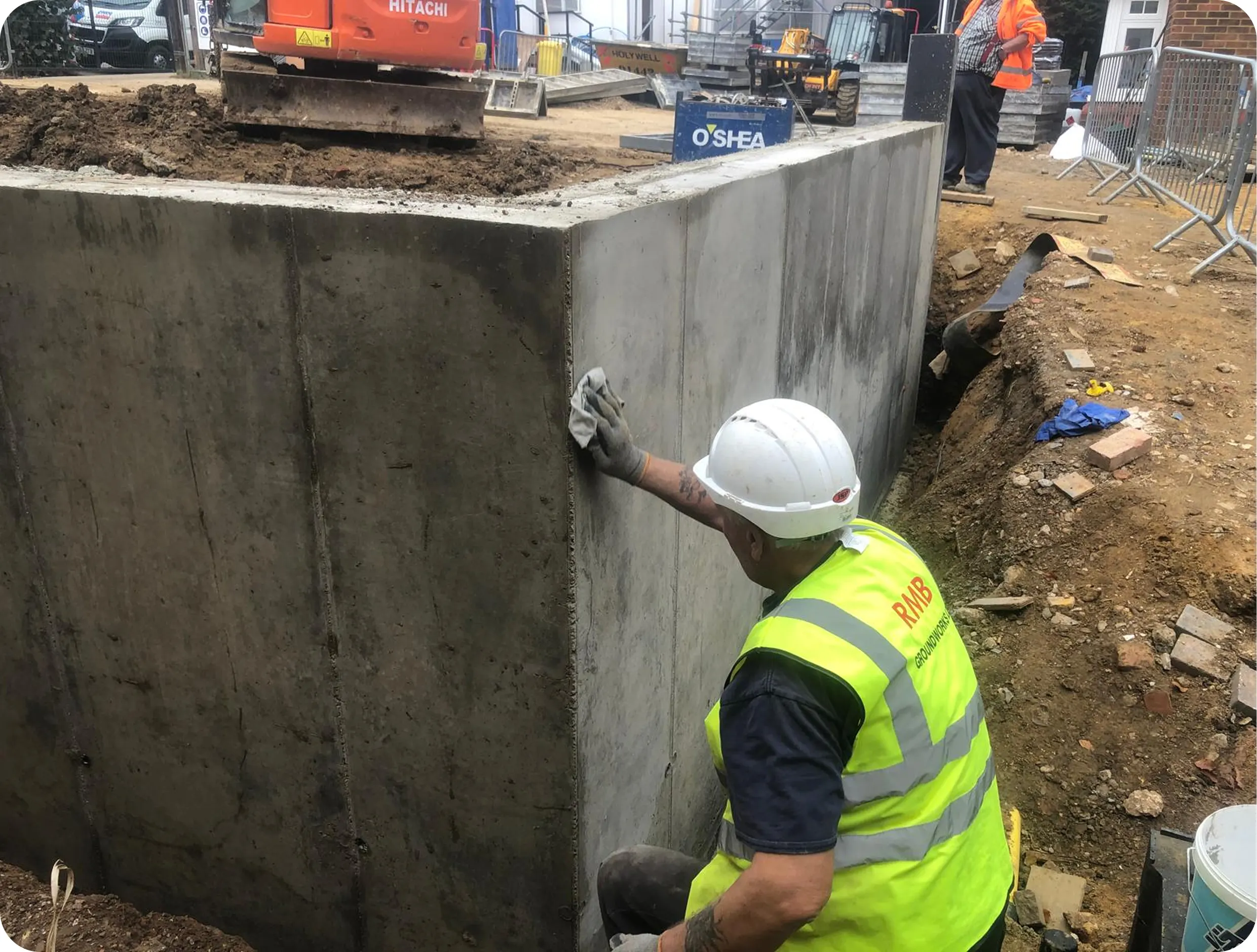 RMB Groundworks operative finishing a concrete retaining wall